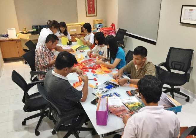 Devotees come together behind the scenes to wrap the gifts and prizes for the appreciation dinner.