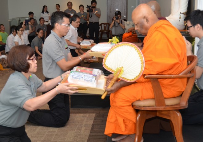 Nalandians making offerings to the Sangha.