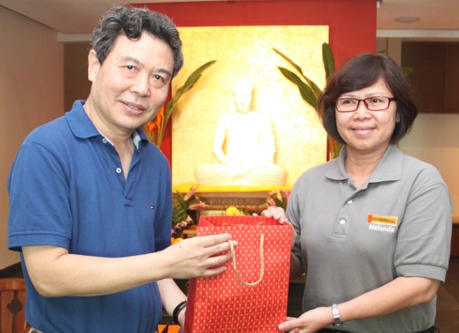 Sis. Evelyn presents a token of appreciation to Bro. Benny.