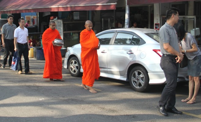 Venerable monks on alms-round at Sri Petaling and Happy Garden markets.