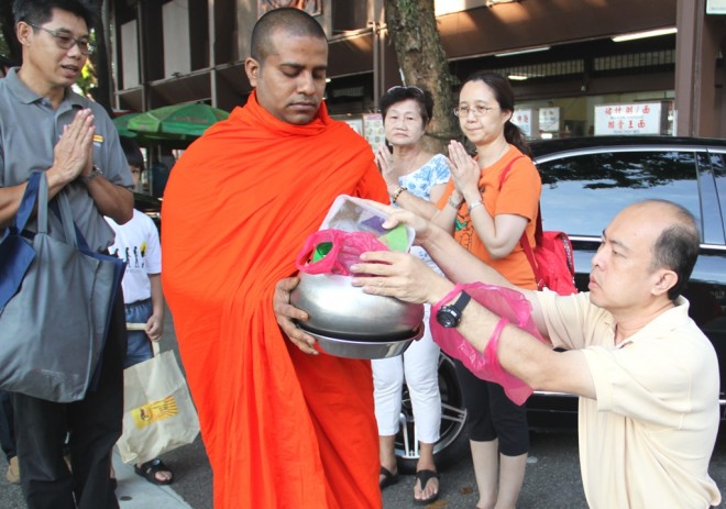 Devotees offering food to the venerable monks.