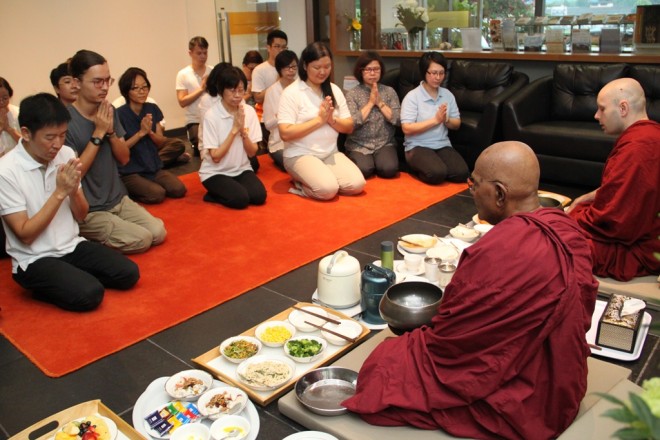 Devotees offering breakfast to Ven. Gunaratana and Ven. Mangala.