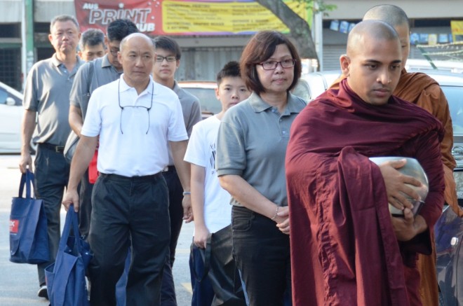 Venerables and volunteers on the first alms-round of the new year at Sri Petaling and Happy Garden market.