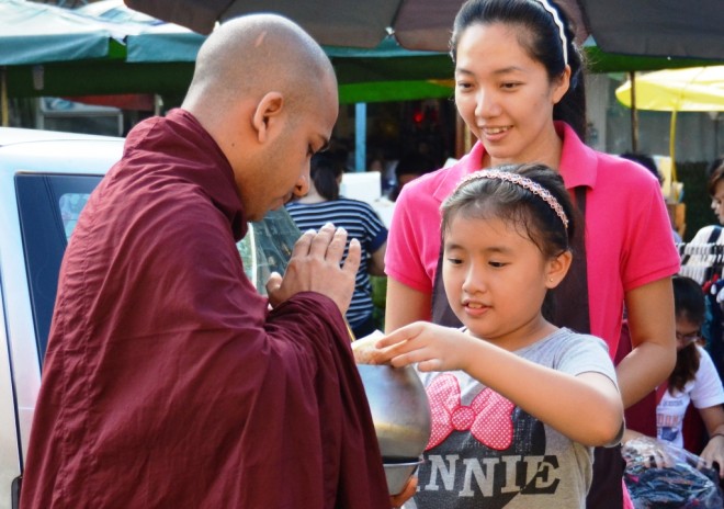 Venerables receiving offerings from devotees.