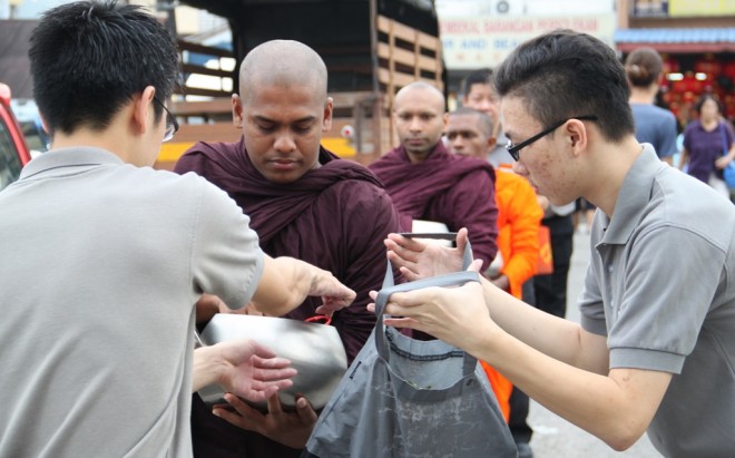 Nalanda volunteers accompanying the venerable monks on alms-round.
