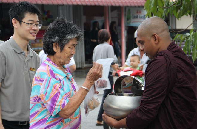 A devotee offering alms-food.