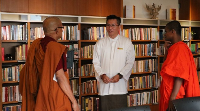 Bro. Charlie showing the venerable monks around the Centre.