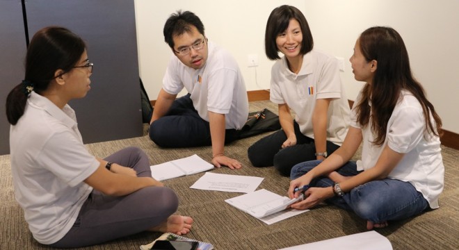 Facilitators in a group discussion to prepare for their presentation.