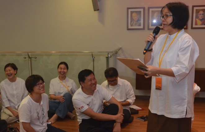 A representative giving a presentation on what was discussed in her group.