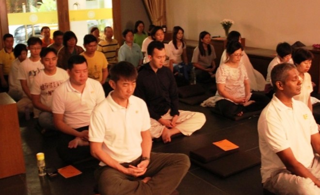 Devotees meditating at the weekly session.