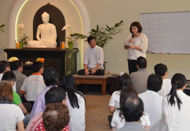 A devotee shares her thoughts during the Service Sunday Dhamma talk.