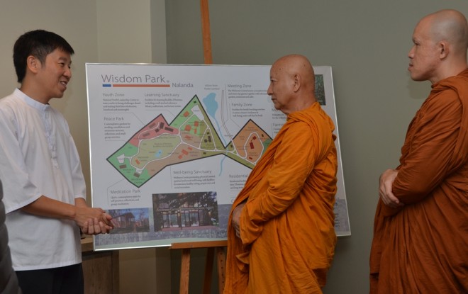 Ven. Dhammavuddho listening attentively to the development plan for Wisdom Park.