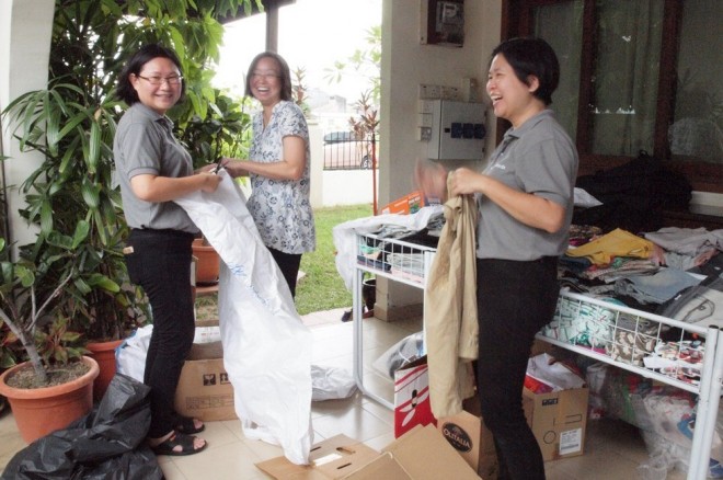 Sorting out children’s clothes for sale.