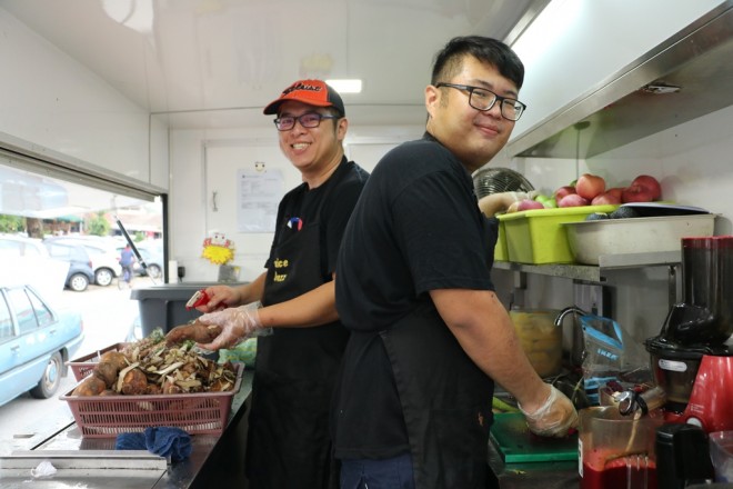 The juice-buzz staff preparing drinks in their mobile shop.