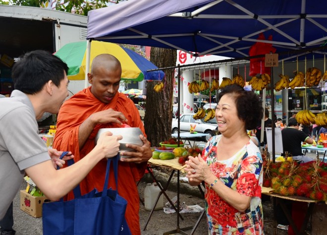 A devotee joyfully perform the wholesome act of dāna.