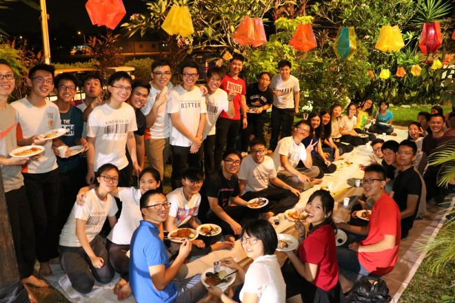 Friends tucking in at the potluck dinner.