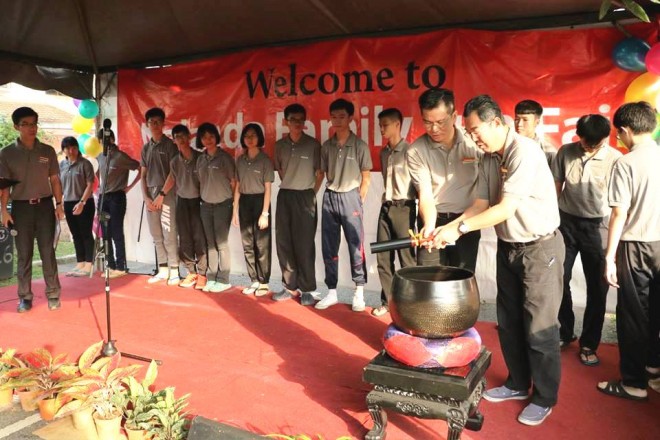 Hitting the gong to mark the official opening of the Fun Fair.
