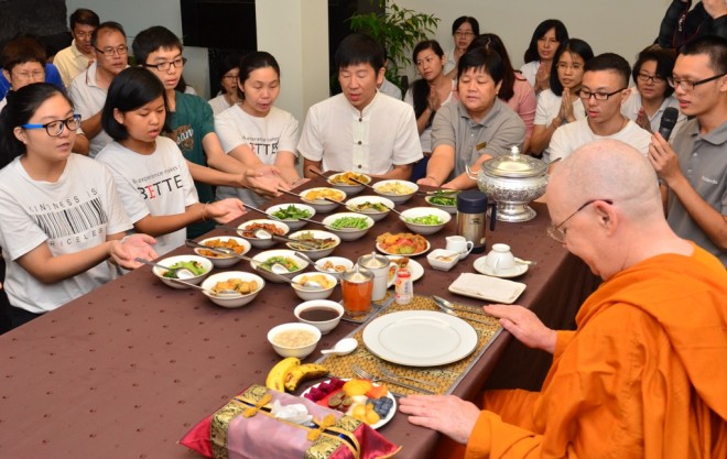 Offering lunch dāna.