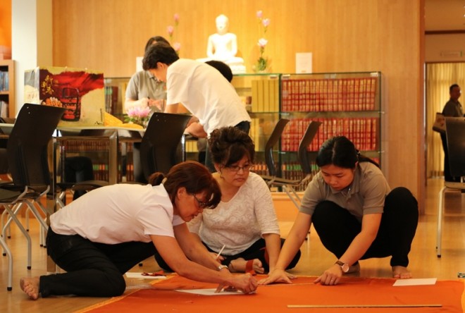 Measuring the cloth and cutting into the right size.