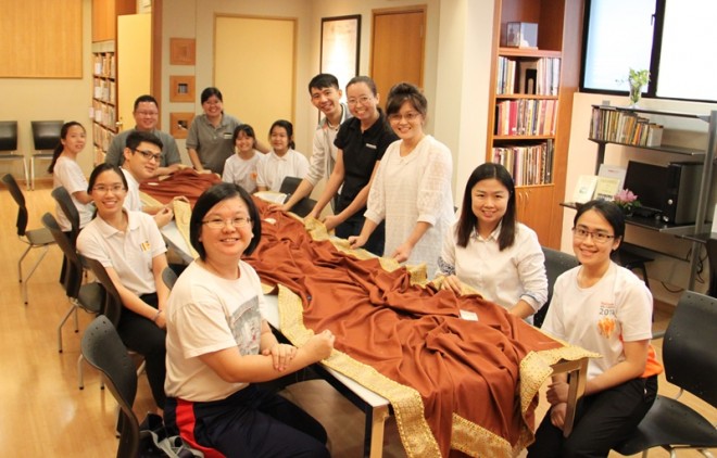 Nalandians feeling joyful to participate in making the robes.