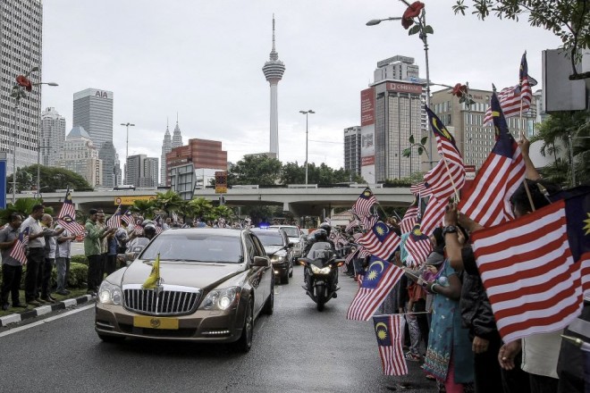 The motorcade passing through the streets of Kuala Lumpur.