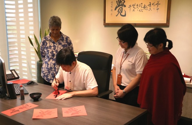 Bro. Tan writing calligraphy for officers this New Year.