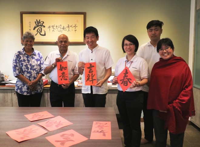 Nalandians gather at the EXCO Room for the writing of New Year calligraphy.