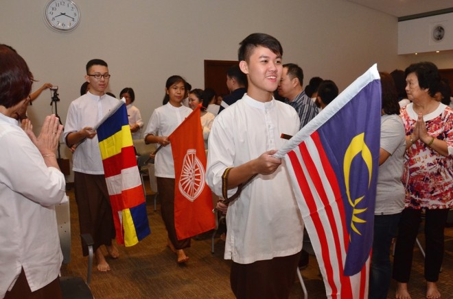 Student leaders lead the traditional procession bearing flags.
