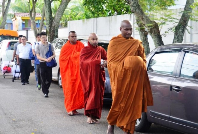 The venerable monks walking to the market followed by a line of volunteer helpers.