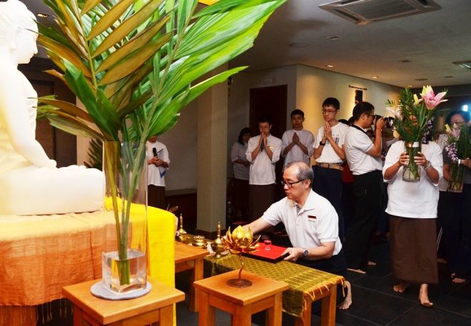 Bro. Ananda Fong leading the offerings to the Buddha, Dhamma, and Sangha. 