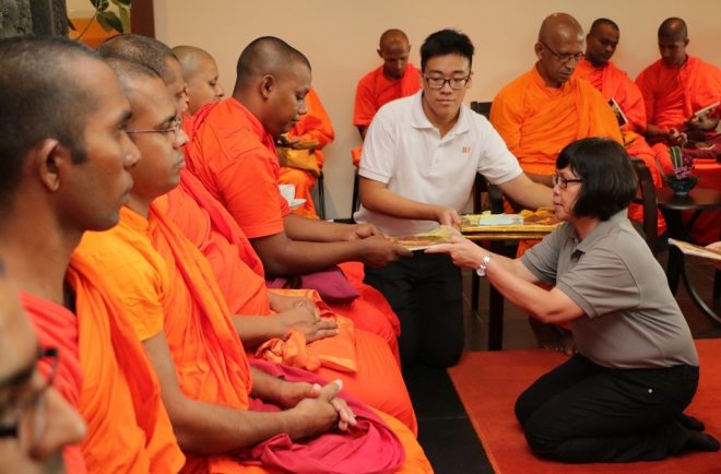President Sis. Evelyn offering requisites to venerable Sangha members.
